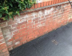 pressure washing a brick wall in Martham, Norfolk