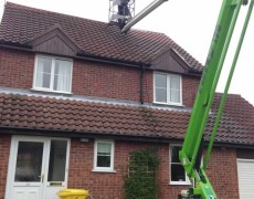 jet washing roof tiles on a house