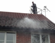 power washing concrete roof tiles on a house