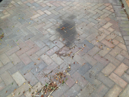 oil stained driveway before specialist treatment & pressure washing
